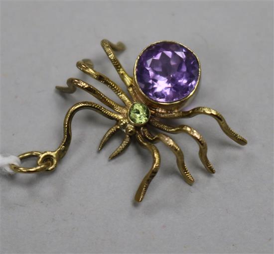 A yellow metal, amethyst and peridot set spider pendant, 25mm.